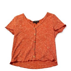 It is a burnt orange button down crop top